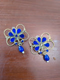 Blue floral statement earrings with gold tone outline and blue drop bead