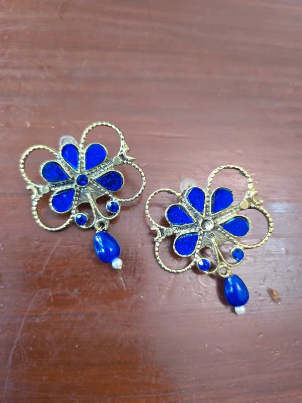 Blue floral statement earrings with gold tone outline and blue drop bead